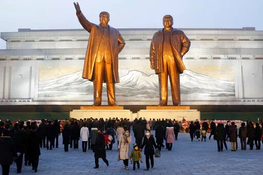 Citizens visit the bronze statues of their late leaders Kim Il Sung, left, and Kim Jong Il on Mansu Hill in Pyongyang, North Korea Thursday, Dec. 16, 2021, on the occasion of 10th anniversary of demise of Kim Jong Il. (AP Photo/Cha Song Ho)