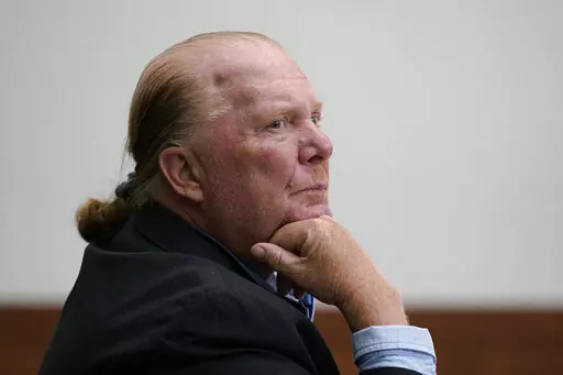Celebrity chef Mario Batali listens at Boston Municipal Court on the first day of his pandemic-delayed trial, Monday, May 9, 2022, in Boston. Batali pleaded not guilty to a charge of indecent assault and battery in 2019, stemming from accusations that he forcibly kissed and groped a woman after taking a selfie with her at a Boston restaurant in 2017. (AP Photo/Steven Senne, Pool)