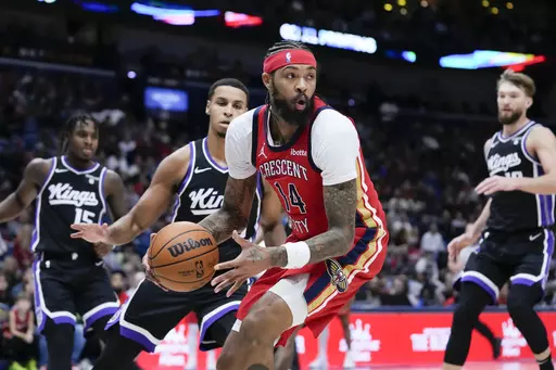 New Orleans Pelicans forward Brandon Ingram (14) looks to pass under the basket in the first half of an NBA basketball game against the Sacramento Kings in New Orleans, Monday, Nov. 20, 2023. (AP Photo/Gerald Herbert)
