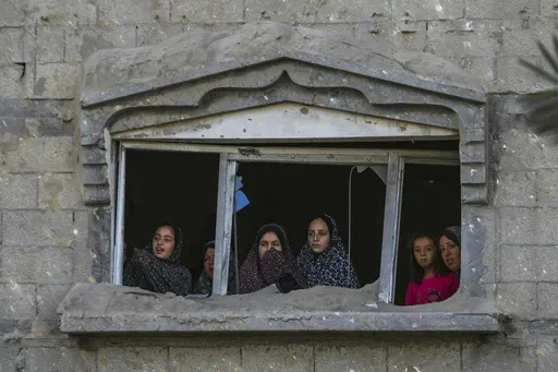 Palestinians look at the destruction after an Israeli airstrike on a crowded tent camp housing Palestinians displaced by the war in Muwasi, Gaza Strip, Sept. 10, 2024. (AP Photo/Abdel Kareem Hana, file)