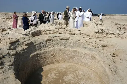 Sheikh Majid bin Saud Al Mualla, chairman of the Umm Al Quwain Department of Tourism and Archaeology, front right, explains to Noura Al Kaabi, UAE Minister of Culture and Youth, during a visit of the ancient Christian monastery on Siniyah Island in Umm al-Quwain, United Arab Emirates, Thursday, Nov. 3, 2022. The monastery possibly dating as far back as the years before Islam rose across the Arabian Peninsula has been discovered on an island off the coast of the UAE officials announced Thursday, 