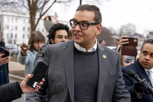 FILE — Rep. George Santos, R-N.Y., leaves a House GOP conference meeting on Capitol Hill, in Washington, Jan. 25, 2023. Santos is carrying on in Congress despite calls for him to resign. Santos admitted to fabricating many aspects of his life story, but the newly elected congressman is refusing calls to quit. (AP Photo/Andrew Harnik, File)