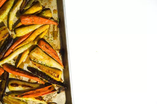 This image released by Milk Street shows a recipe for roasted carrots with the turmeric-infused honey. (Milk Street via AP)