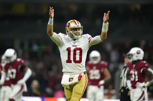 San Francisco 49ers quarterback Jimmy Garoppolo reacts after tight end George Kittle scored a touchdown during the second half of an NFL football game against the Arizona Cardinals, Monday, Nov. 21, 2022, in Mexico City. (AP Photo/Marcio Jose Sanchez)