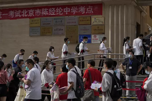 Students line up to enter a school for the first day of China's national college entrance examinations, known as the gaokao, in Beijing, Tuesday, June 7, 2022. After the pandemic, young Chinese are again looking to study abroad. But the decades-long run that has sent an estimated 3 million Chinese students to the U.S. could be trending down. (AP Photo/Andy Wong, File )