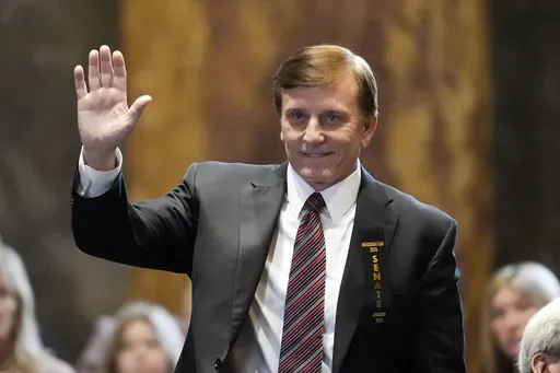 Louisiana State Treasurer John Fleming, waves as he is introduced during the swearing in of the Louisiana state legislature in Baton Rouge, La., Monday, Jan. 8, 2024. (AP Photo/Gerald Herbert, Pool, File)