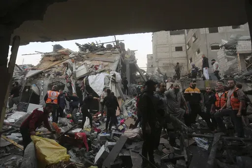 Palestinians look for survivors of the Israeli bombardment of the Gaza Strip in Rafah on Tuesday, Dec. 12, 2023. A wartime opinion poll among Palestinians shows a rise in support for Hamas, even in the devastated Gaza Strip. The survey published Wednesday, Dec. 13, 2023 also reflected an overwhelming rejection of Western-backed President Mahmoud Abbas, with nearly 90% saying he must resign. (AP Photo/Hatem Ali)