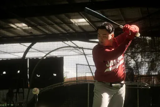 Stanford baseball player Rintaro Sasaki swings in the batting cage area at the Sunken Diamond baseball field at Stanford University in Stanford, Calif., Friday, Feb. 7, 2025. (AP Photo/Jeff Chiu)