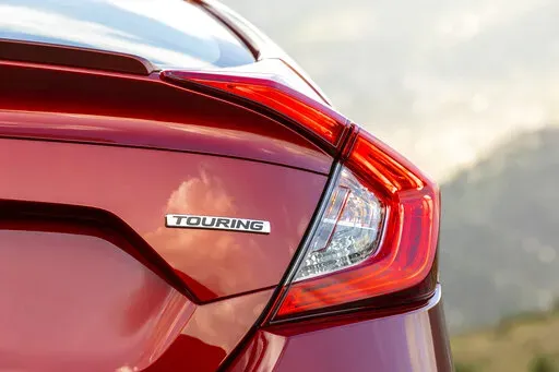 This undated photo provided by American Honda Motor Co. shows a trim name on a Honda Civic. In the trim lineup, Touring trims are typically more loaded with features than entry-level LX trims. (Courtesy of American Honda Motor Co. via AP)