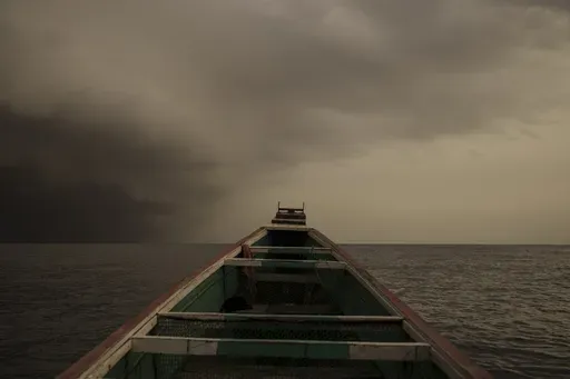 The bow of a pirogue, a typical Senegalese fishing boat that's also used by migrants bound for Europe, as a storm approaches near Dakar, Senegal, Monday, Sept. 4, 2023. (AP Photo/Felipe Dana)