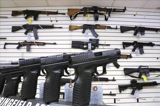 Semi-automatic guns are displayed for sale at Capitol City Arms Supply, Jan. 16, 2013, in Springfield, Ill. Illinois will soon outlaw advertising for firearms that officials determine produces a public safety threat or appeals to children, militants or others who might later use them illegally, as the state continues its quest to curb mass shootings. (AP Photo/Seth Perlman, File)