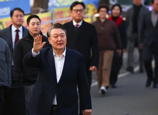 Impeached South Korean President Yoon Suk Yeol greets his supporters after he came out of a detention center in Uiwang, South Korea, Saturday, March 8, 2025. (Kim Do-hun/Yonhap via AP)