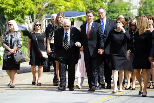 Raymond Blanco, center left, walks with family from the Cateral Hall to the Reflections and Mass of Christian Burial for Gov. Kathleen Blanco at The Cathedral of St. John the Evangelist on Aug. 24, 2019, in Lafayette, La. Raymond Blanco, a former coach, longtime academic administrator at the University of Louisiana at Lafayette and husband to the state’s first female governor, died Saturday, Nov. 19, 2022, at 87 years old. (Brad Kemp/The Advocate via AP, File)