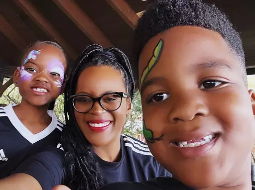 This image provided by Lakesha Cole shows Kirby, Lakesha and Keegan Cole during winter school break on December 30, 2022, at Legoland in Winter Haven, Fla. Family fun and a flexible schedule are priorities during school breaks, but Cole begins putting systems in place to organize her home and get her kids on an early bedtime schedule ahead of the first day of school. (Lakesha Cole via AP)