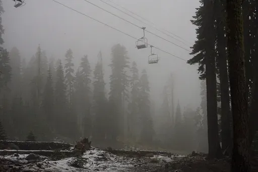 A coating of snow is seen below ski lifts at Sugarbowl Ski Resort Saturday, Aug. 24, 2024, in Donner Summit, Calif. (AP Photo/Brooke Hess-Homeier)