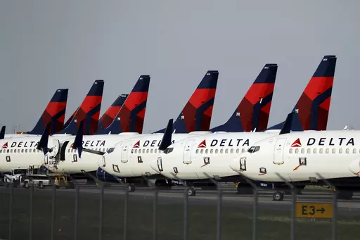 In this April 1, 2020, file photo, several dozen Delta Air Lines jets are parked at Kansas City International Airport in Kansas City, Mo. Delta is backtracking slightly on changes it previously announced in its frequent-flyer program, but it still plans to reshape SkyMiles to favor big spenders over customers who take the most flights. Delta outlined the revisions in an email from CEO Ed Bastian to SkyMiles members on Wednesday, Oct. 18, 2023. (AP Photo/Charlie Riedel, File)