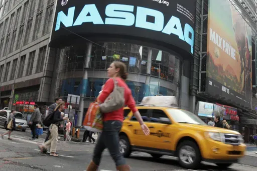 Commuters traverse New York's Times Square in front of the Nasdaq MarketSite, Wednesday, May 16, 2012. (AP Photo/Richard Drew, File)