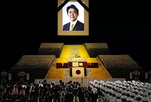 A portrait of former Japanese Prime Minister Shinzo Abe hangs on the stage during his state funeral, Tuesday, Sept. 27, 2022, Tokyo. Abe was assassinated in July. (Franck Robichon/Pool Photo via AP)