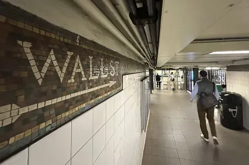 Commuters leave a Wall St. subway station in New York's Financial District on Oct. 23, 2024. (AP Photo/Peter Morgan, File)