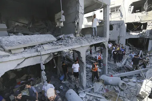 Palestinians look for survivors after Israeli airstrikes in Gaza City, Gaza Strip, Wednesday, Oct. 18, 2023. Many Palestinians in Gaza who heeded the Israeli military's warnings last week advising them to head south thought they were fleeing to a safer place. But they watched as dozens of people like them met the same grim fate they were running from: killed by Israeli airstrikes raining down on residential towers and United Nations shelters, outside the evacuation zone. (AP Photo/Abed Khaled, F