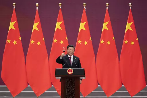 Chinese President Xi Jinping raises his glass and proposes a toast during the welcome banquet for visiting leaders attending the Belt and Road Forum at the Great Hall of the People, on April 26, 2019. China's Belt and Road Initiative looks to become smaller and greener after a decade of big projects that boosted trade but left big debts and raised environmental concerns. (Nicolas Asfouri/Pool Photo via AP, File)