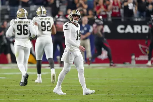 New Orleans Saints quarterback Andy Dalton (14) reacts after throwing his second interception that was returned for a touchdown, during the first half of an NFL football game against the Arizona Cardinals, Thursday, Oct. 20, 2022, in Glendale, Ariz. (AP Photo/Matt York)
