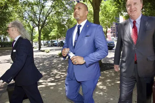 Jeffrey Vappie, center, a former police bodyguard for New Orleans Mayor LaToya Cantrell, walks into federal court in New Orleans, Wednesday Aug., 7, 2024. (Chris Granger/The Times-Picayune/The New Orleans Advocate via AP)
