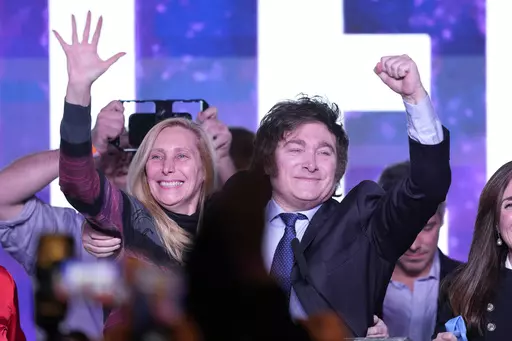 Javier Milei, presidential candidate of the Liberty Advances coalition, embraces his sister Karina at his campaign headquarters after polling stations closed during primary elections in Buenos Aires, Argentina, Sunday, Aug. 13, 2023. (AP Photo/Natacha Pisarenko)