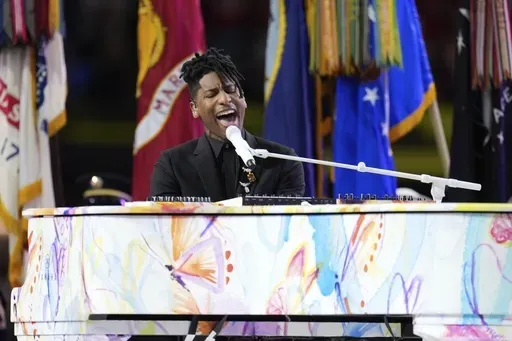 Jon Batiste performs the national anthem before the NFL Super Bowl 59 football game between the Kansas City Chiefs and the Philadelphia Eagles, Sunday, Feb. 9, 2025, in New Orleans. (AP Photo/George Walker IV)