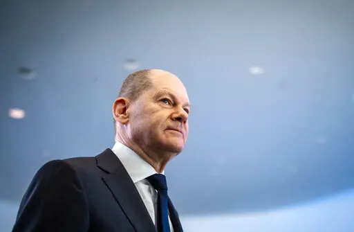 German Chancellor Olaf Scholz leaves after a news conference, ahead of a one-day closed meeting of the German Cabinet at the Chancellery in Berlin, Germany, Friday, Jan. 21, 2022.  Scholz is flying to Washington this week to reassure Americans that his country stands alongside the United States and other NATO partners in opposing any Russian aggression against Ukraine. Scholz has publicly said that Moscow would pay a “high price” in the event of an attack. But his government’s refusal to s