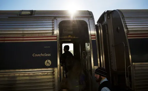 Passengers board an Amtrak train heading to New Orleans from Atlanta on Nov. 23, 2016. The federal government sued Norfolk Southern railroad on Tuesday, July 30, 2024, over chronic delays for Amtrak between New York and New Orleans. (AP Photo/David Goldman, File)