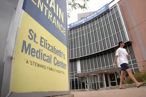 A passer-by walks past an entrance to St. Elizabeth's Medical Center, Thursday, Sept. 19, 2024, in the Brighton neighborhood of Boston. (AP Photo/Steven Senne)
