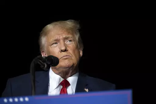 Former President Donald Trump pauses while speaking at a rally at the Minden Tahoe Airport in Minden, Nev., on Oct. 8, 2022. Trump is scheduled to answer questions under oath, Wednesday, Oct. 19, 2022, in a lawsuit filed by E. Jean Carroll, a magazine columnist who says the Republican raped her in the mid-1990s in a department store dressing room. (AP Photo/José Luis Villegas, Pool, File)