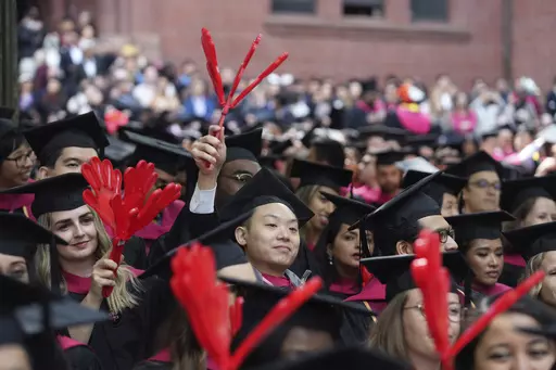 Harvard University students celebrate their graduate degrees in public health during Harvard commencement ceremonies, Thursday, May 25, 2023, in Cambridge, Mass. A pause on student loan payments that's been in place since the start of the COVID pandemic will end late this summer if Congress approves a debt ceiling and budget deal negotiated by House Speaker Kevin McCarthy and President Joe Biden. (AP Photo/Steven Senne, File)
