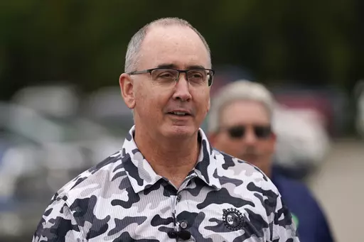 United Auto Workers President Shawn Fain talks with members picketing near a General Motors Assembly Plant in Delta Township, Mich., Friday, Sept. 29, 2023. Fain will update members on bargaining with Detroit's three automakers on Friday afternoon, (AP Photo/Paul Sancya, File)