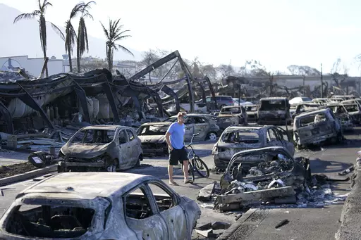 A man walks through wildfire wreckage in Lahaina, Hawaii, Aug. 11, 2023. Federal authorities have started removing hazardous materials from the Maui wildfires and laying the groundwork to dispose of burnt cars, buildings and other debris. The hazardous materials, including oil, solvent and batteries, are being shipped to the West Coast while the U.S. Army Corps of Engineers works with local officials to develop a plan to dispose of an estimated 400,000 to 700,000 tons of debris on the island. (A