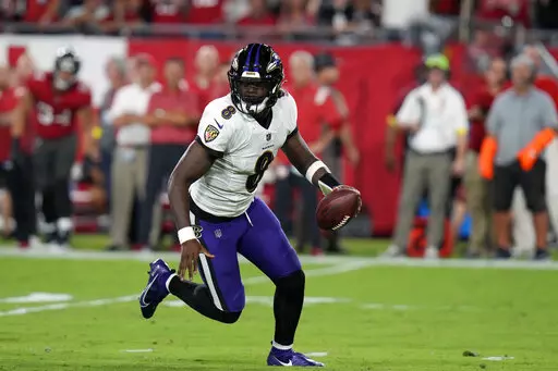 Baltimore Ravens quarterback Lamar Jackson scrambles during the first half of an NFL football game against the Tampa Bay Buccaneers Thursday, Oct. 27, 2022, in Tampa, Fla. (AP Photo/Chris O'Meara)