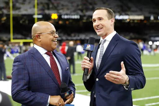 NBC Sports commentators Mike Tirico, left, and former New Orleans Saints quarterback Drew Brees broadcast from the field before an NFL football game between the New Orleans Saints and the Buffalo Bills, Thursday, Nov. 25, 2021, in New Orleans. Brees put his broadcasting career on hold after one year to spend weekends with his family. Going back to the booth or studio is always a possibility for the 13-time Pro Bowl quarterback who worked in a variety of roles for NBC last season. (AP Photo/Tyler