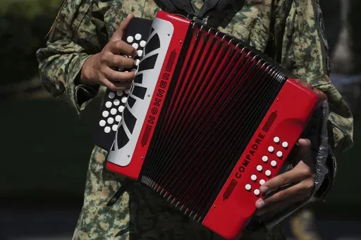 A soldier plays an accordion during the performance of a corrido for the media at a military base in Mexico City, Monday, March 10, 2025. (AP Photo/Fernando Llano)