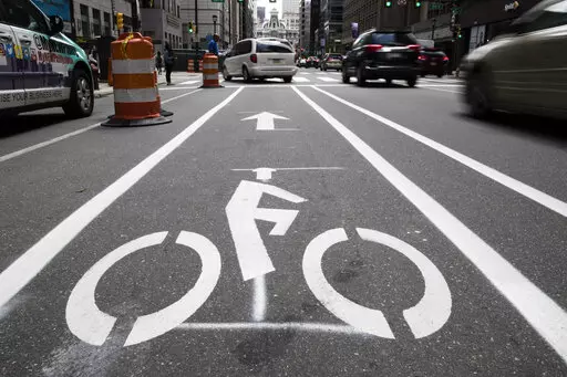 A bicycle lane along Market Street in Philadelphia, on June 4, 2018. The government has a fresh warning to states seeking billions of dollars from President Joe Biden's infrastructure law to widen roads: protect the safety of pedestrians and bicyclists or risk losing funds. In a new report submitted to Congress, the Transportation Department says it will now aim to prioritize the safety and health of all the users of a roadway, not just cars. (AP Photo/Matt Rourke, File)