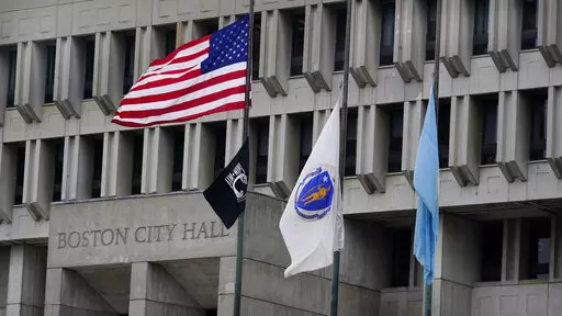 The American flag, the Commonwealth of Massachusetts flag, and the City of Boston flag, from left, fly outside Boston City Hall, Monday, May 2, 2022, in Boston. A unanimous Supreme Court has ruled that Boston violated the free speech rights of a conservative activist when it refused his request to fly a Christian flag on a flagpole outside City Hall. Justice Stephen Breyer wrote for the court Monday that the city discriminated against the activist because of his "religious viewpoint," even thoug