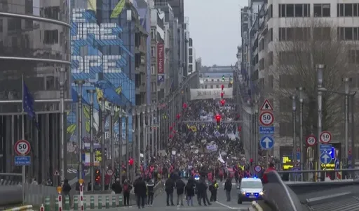 In this grab taken from video, climate activists take part in a march, in Brussels, Sunday, Dec. 3, 2023. Thousands of people have marched through the center of Brussels in a boisterous rally highlighting the dangers of climate change, as the COP28 climate summit draws to an end in the United Arab Emirates. (AP)