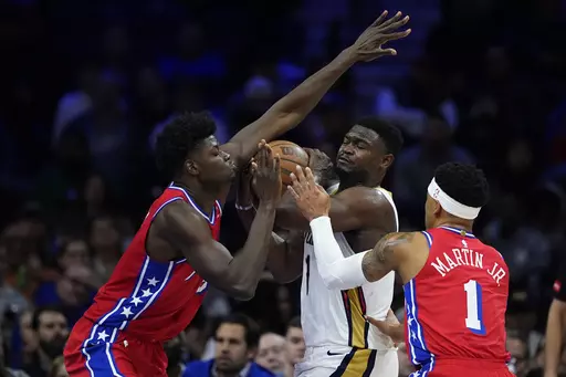 New Orleans Pelicans' Zion Williamson, center, tries to get a shot past Philadelphia 76ers' Mo Bamba, left, and KJ Martin during the first half of an NBA basketball game, Friday, March 8, 2024, in Philadelphia. (AP Photo/Matt Slocum)
