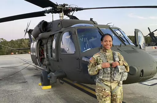 This undated photo provided by Louisiana National Guard shows Louisiana Army National Guard Warrant Officer Tatiana Julien in front of her National Guard helicopter. The Louisiana Army National Guard has commissioned its first Black female pilot. Warrant Officer Tatiana Julien of New Orleans pilots a UH-60 Black Hawk helicopters in B Company, 1-244th Assault Helicopter Battalion, which is based in Hammond. She says in a news release that she had no idea she'd be a trailblazer when she asked for 