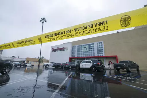 A police yellow tape is seen at the scene where two people were struck by gunfire in a shooting at a Burlington store — part of a chain formerly known as Burlington Coat Factory in North Hollywood, Calif., Thursday, Dec. 23, 2021. (AP Photo/Ringo H.W. Chiu)