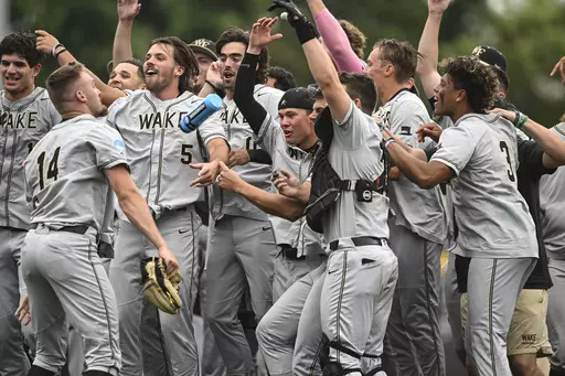 Wake Forest celebrates after winning an NCAA college baseball tournament super regional game against Alabama, Sunday, June 11, 2023, in Winston-Salem, N.C. (AP Photo/Matt Kelley)