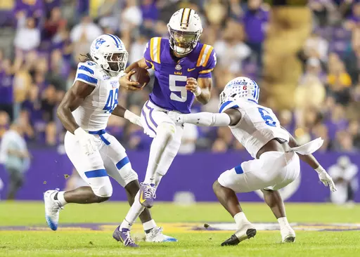 LSU quarterback Jayden Daniels, center, runs the ball against Georgia State during an NCAA college football game in Baton Rouge, La., Saturday, Nov. 18, 2023. (Scott Clause/The Daily Advertiser via AP)