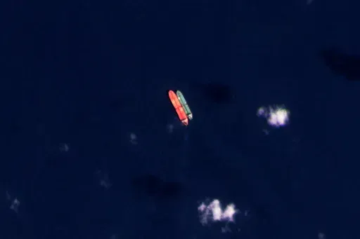 In this satellite photo provided by Planet Labs PBC, vessels identified as the Virgo, left, and the Suez Rajan, by the advocacy group United Against Nuclear Iran, are seen in the South China Sea on Feb. 13, 2022. A Greek shipper has pleaded guilty to a charge over it smuggling sanctioned Iranian crude oil and agreed to pay a $2.4 million fine, U.S. federal court papers seen Thursday, Sept. 7, 2023 by The Associated Press show. (Planet Labs PBC via AP, File)
