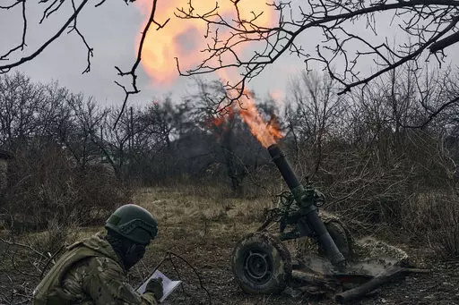 Volunteer soldiers fire towards Russian positions close to Bakhmut, Donetsk region, Ukraine, Wednesday, March 8, 2023. (AP Photo/Libkos)