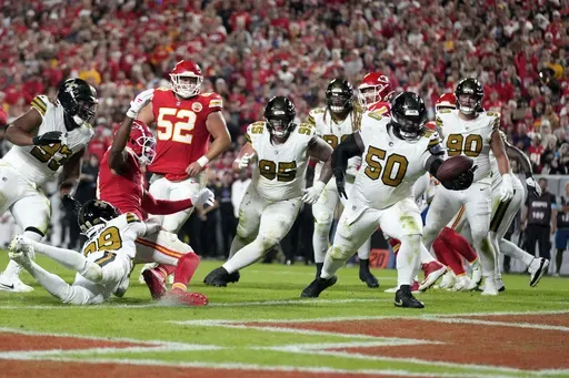 New Orleans Saints defensive tackle Khalen Saunders (50) intercepts a pass in the end zone during the second half of an NFL football game against the Kansas City Chiefs Monday, Oct. 7, 2024, in Kansas City, Mo. (AP Photo/Ed Zurga)